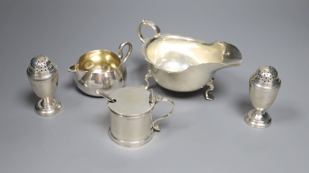 A Victorian silver cream jug, London, 1860, a later silver mustard, sauceboat and pair of pepperettes,